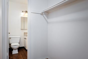 A white toilet is in a small bathroom.